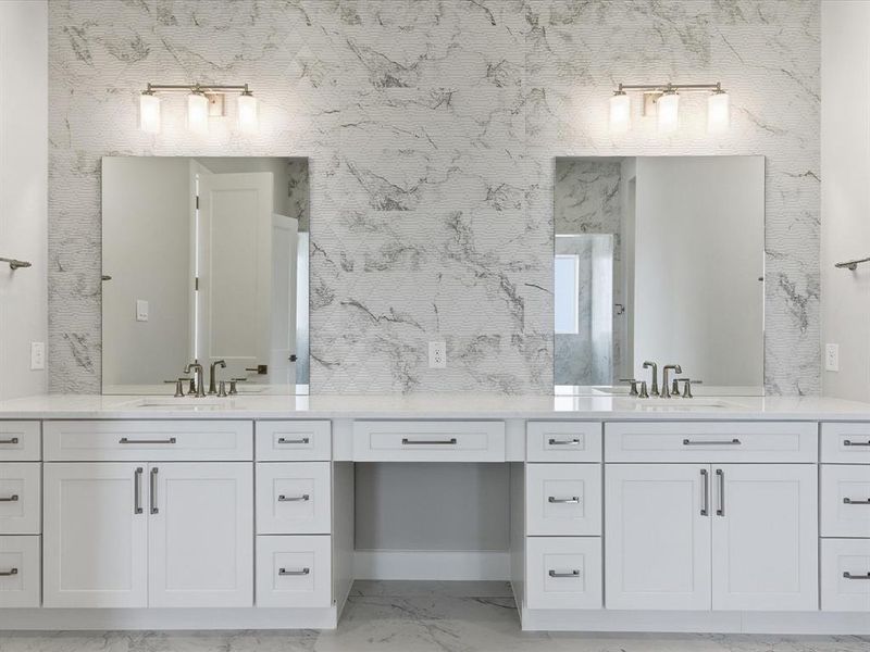 Full bath with double vanity and light marble finish floors Full bath with double vanity and light marble finish floors