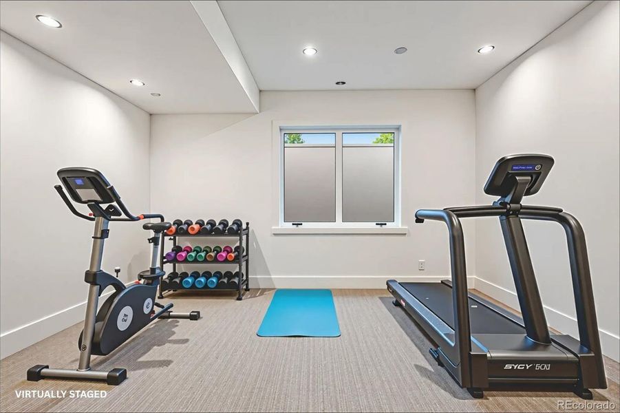 Lower level gym that can be converted into a bedroom. *This photo has been virtually staged