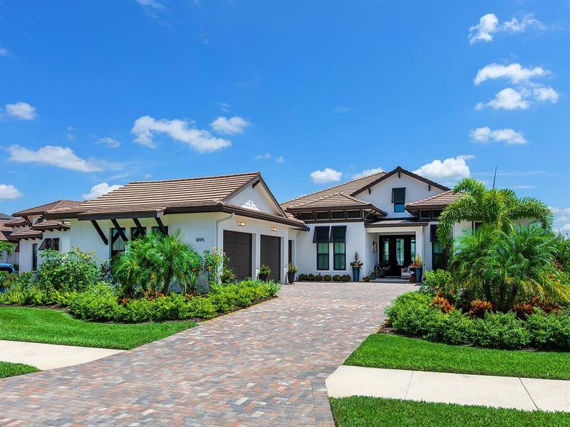 Front exterior of a new home in Wild Blue at Waterside, Sarasota, FL, highlighting curb appeal (Image 21). Front exterior of a new home in Wild Blue at Waterside, Sarasota, FL, highlighting curb appeal (Image 21).