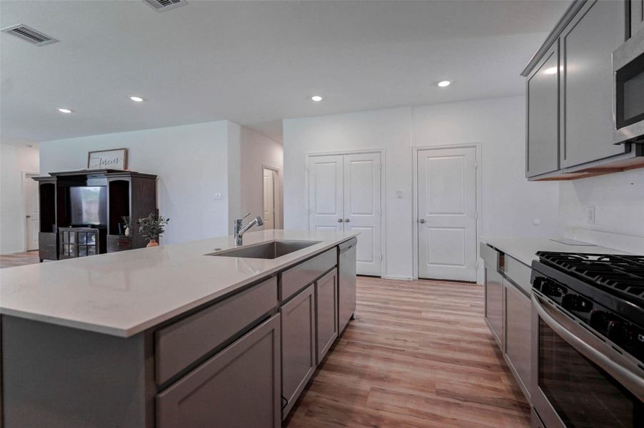 Enjoy an oversized island with deep sink, quartz counters, and tons of cabinet space! Open layout flows into living room—perfect for hosting in Sunterra, Katy TX. Enjoy an oversized island with deep sink, quartz counters, and tons of cabinet space! Open layout flows into living room—perfect for hosting in Sunterra, Katy TX.