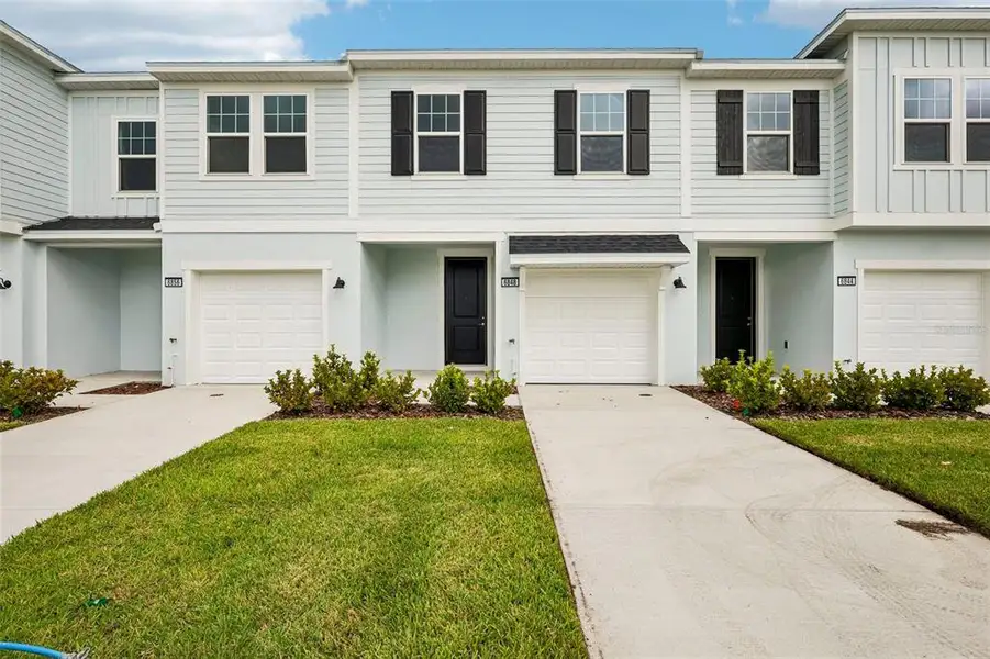 Front exterior of a new home in Twin Oaks, Zephyrhills, FL, highlighting curb appeal (Image 1). Front exterior of a new home in Twin Oaks, Zephyrhills, FL, highlighting curb appeal (Image 1).