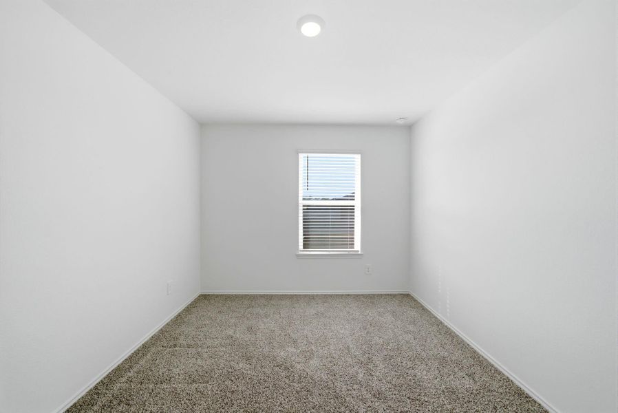 Bright 1st secondary bedroom with ample natural light and a roomy closet—comfort and storage ready.