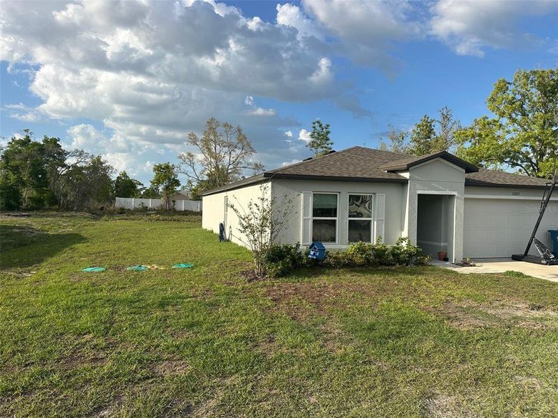 Front exterior of a new home in Spring Hill Classic, Weeki Wachee, FL, highlighting curb appeal (Image 21).