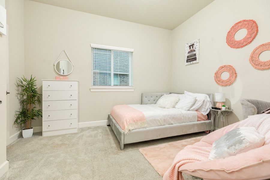 The secondary bedroom in this home is spacious and offers a great layout.