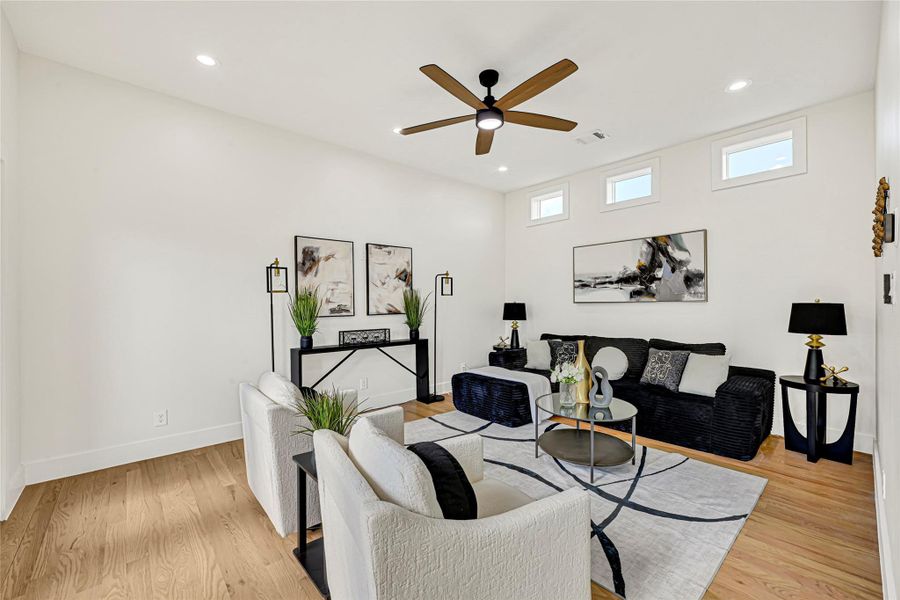 Gleaming wood floor and high ceiling with plenty of natural lighting