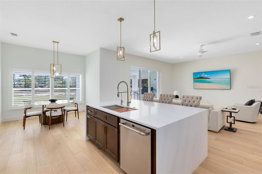 A view from the kitchen into the breakfast nook and living room.