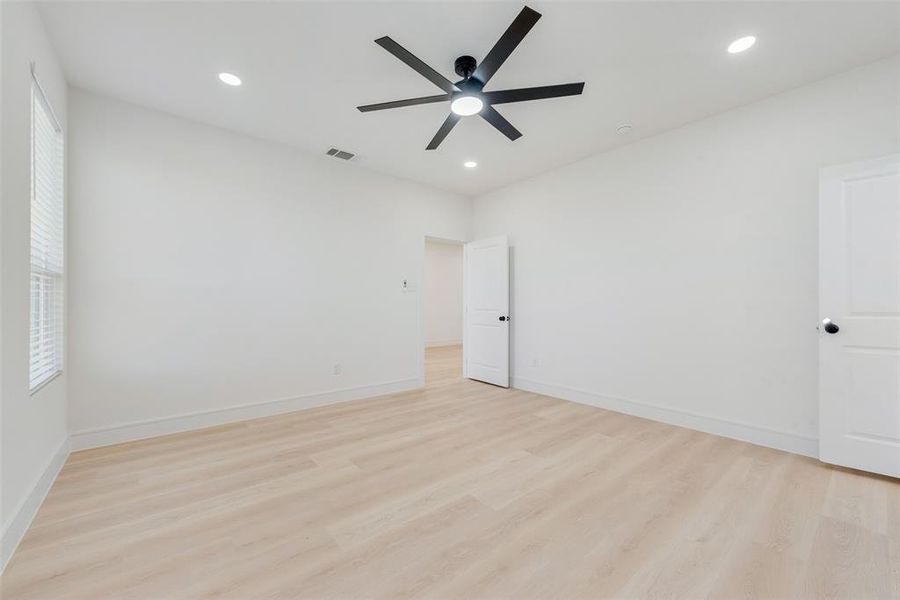 Unfurnished room featuring ceiling fan, light hardwood / wood-style flooring, and plenty of natural light