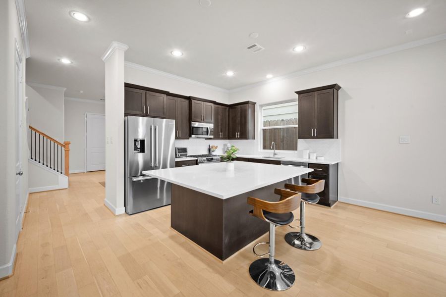 Another angle on the kitchen shows just how much space is here — wide-open flow to the living area, oversized island, and pre-wired for pendant lighting above. Another angle on the kitchen shows just how much space is here — wide-open flow to the living area, oversized island, and pre-wired for pendant lighting above.