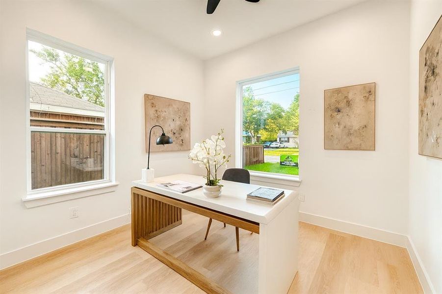 Office space with light wood-style floors, recessed lighting, and a ceiling fan