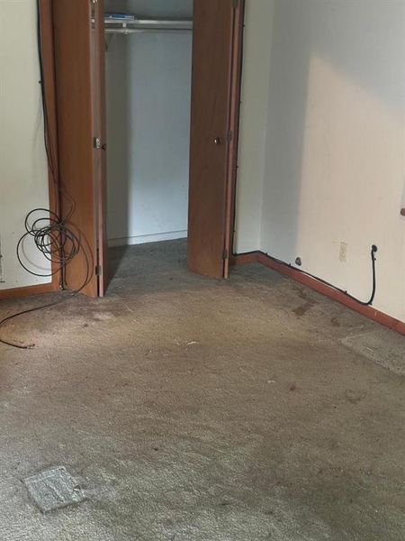 Unfurnished bedroom featuring baseboards and a closet