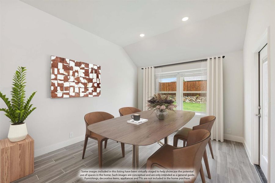 Dining room with vaulted ceiling, wood table, six chairs, and sliding glass door to backyard Dining room with vaulted ceiling, wood table, six chairs, and sliding glass door to backyard