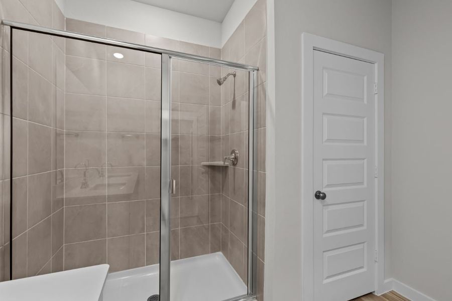 A shower with a glass door. A shower with a glass door.