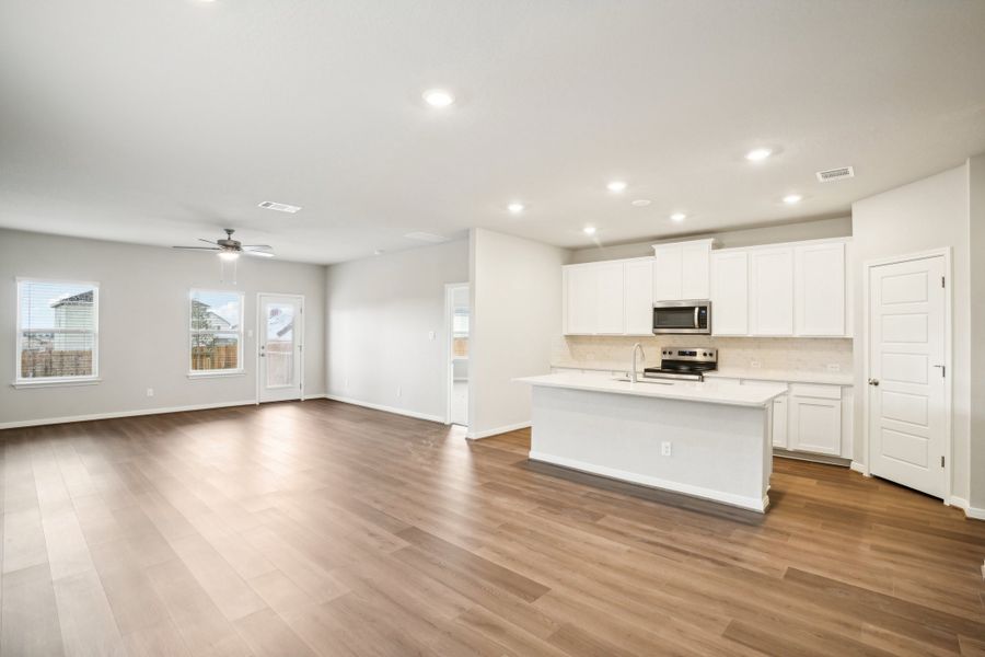 Dining room and kitchen of the Reynolds floorplan at a Meritage Homes community.