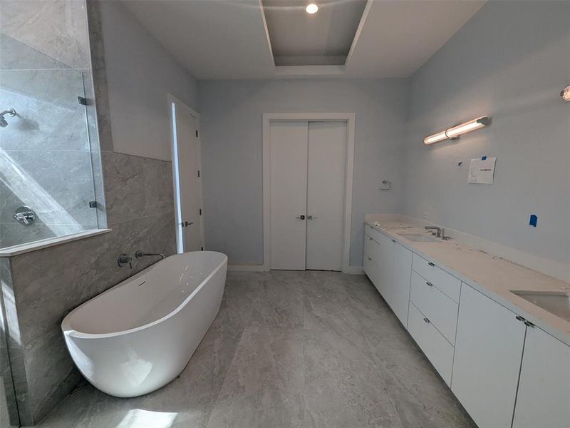 Master bath with tub and double vanities.