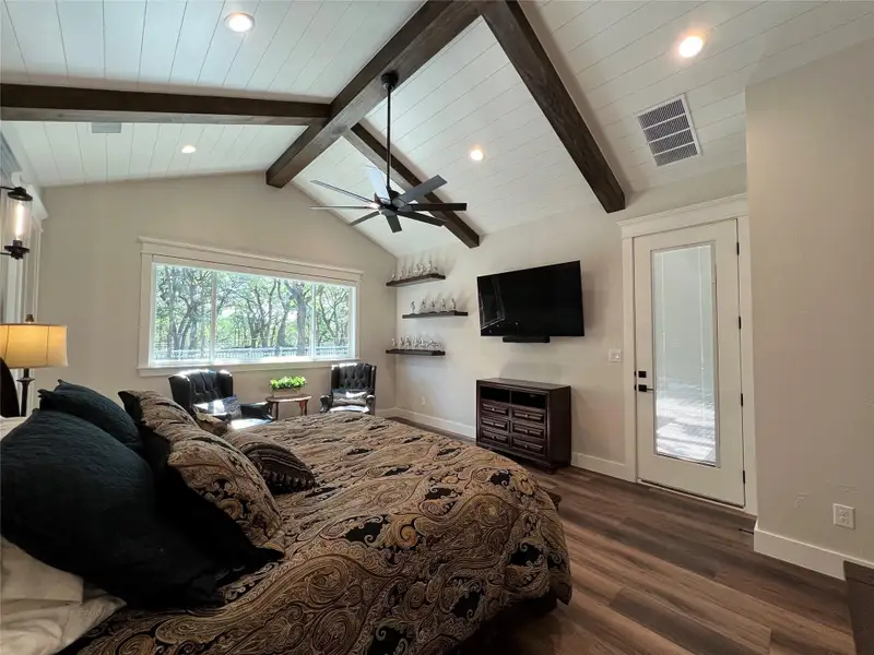 Primary Bedroom with access to back patio, wood beams and recessed lights Primary Bedroom with access to back patio, wood beams and recessed lights