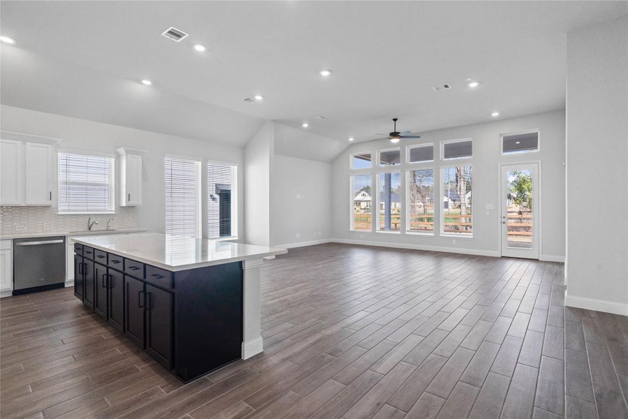 Enjoy an open, airy living experience with a commanding view from the heart of the home. This gourmet kitchen seamlessly flows into the main living area, where oversized windows flood the entire space with abundant natural light and frame a picturesque view of the serene backyard. Enjoy an open, airy living experience with a commanding view from the heart of the home. This gourmet kitchen seamlessly flows into the main living area, where oversized windows flood the entire space with abundant natural light and frame a picturesque view of the serene backyard.