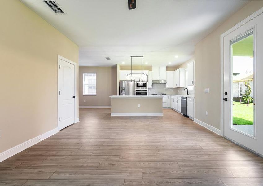 The family room leads to a gorgeous white kitchen.