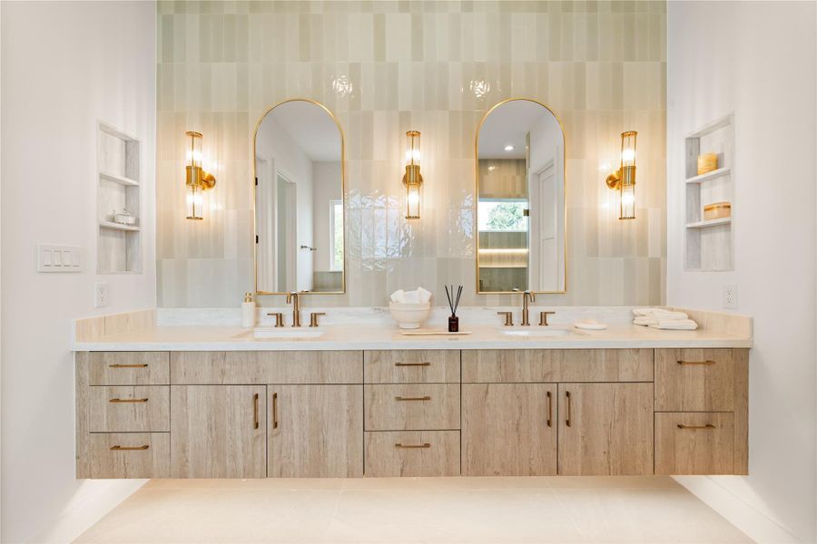 Warm wood tone cabinetry against soft tile creates a spa-like calm here, with enough counter space and storage to keep both sides of the vanity clutter-free. It's a bathroom that earns its place next to a primary suite this size.