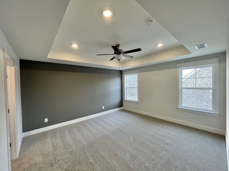 Owner's suite features accent wall, tray ceiling, fan and LED lights Owner's suite features accent wall, tray ceiling, fan and LED lights