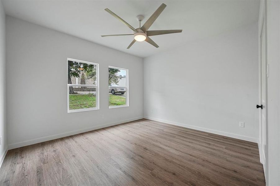 Spare room featuring ceiling fan and wood-type flooring