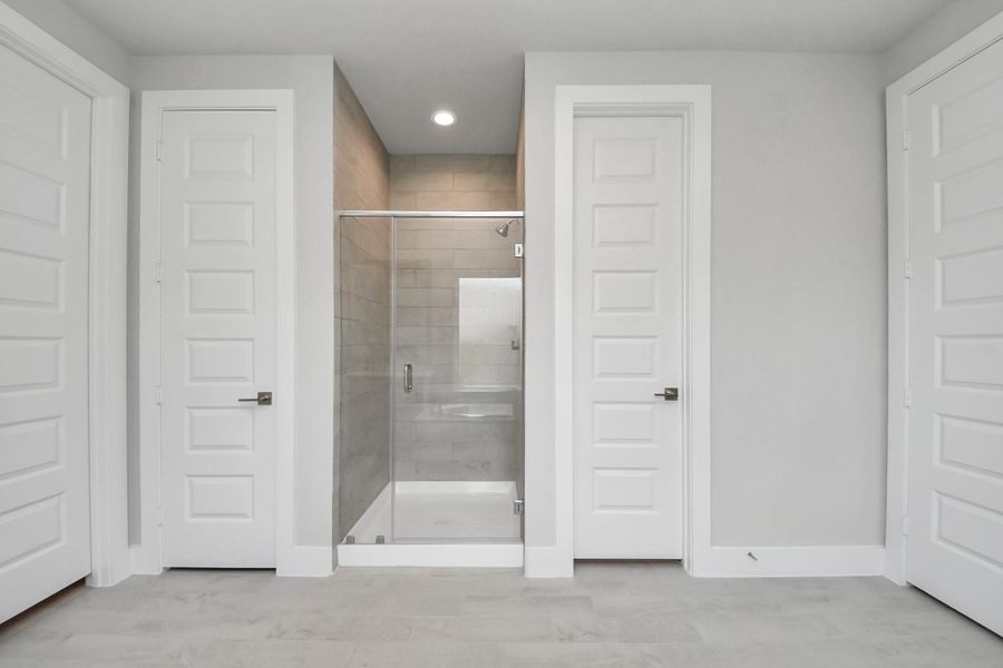 Indulge in a spa-like retreat within the confines of this primary bathroom. Delight in a spacious walk-in shower enveloped in stylish tile surround, unwind in a separate garden tub adorned with custom detailing. Indulge in a spa-like retreat within the confines of this primary bathroom. Delight in a spacious walk-in shower enveloped in stylish tile surround, unwind in a separate garden tub adorned with custom detailing.