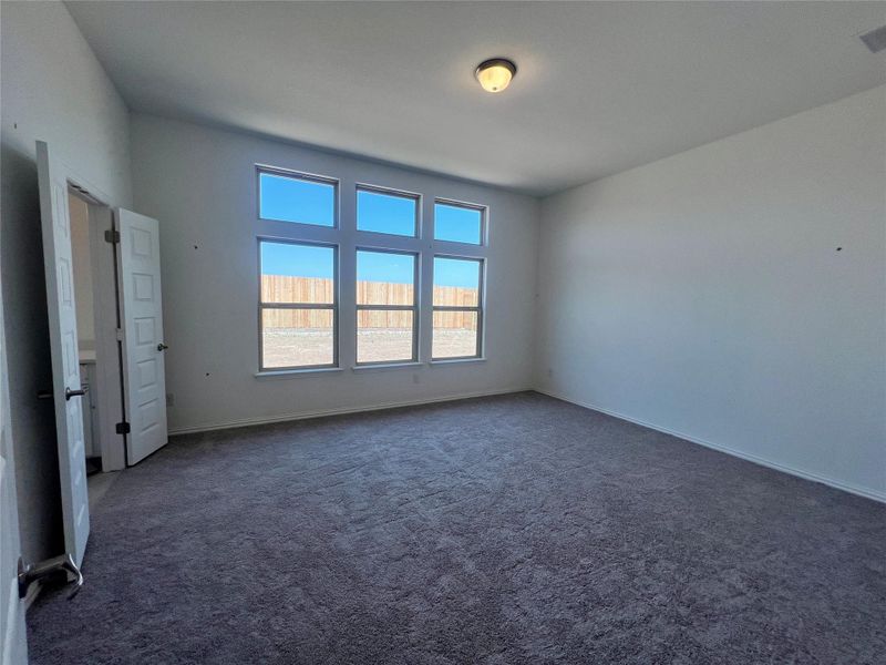 Unfurnished bedroom featuring carpet flooring and baseboards