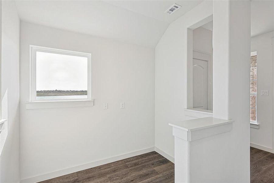 Unfurnished room featuring dark hardwood / wood-style floors