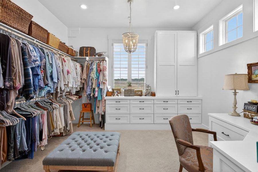 There are TWO primary closets. This one captures the natural light and was designed with its own built-in make-up area and has a Podcast room.