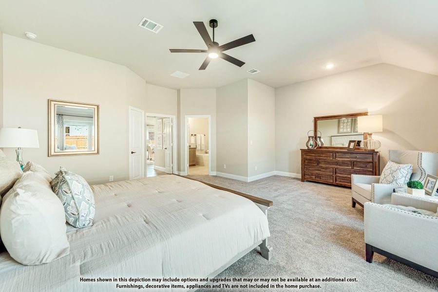 Spacious master bedroom with vaulted ceiling, ceiling fan, carpet, and ensuite bathroom access Spacious master bedroom with vaulted ceiling, ceiling fan, carpet, and ensuite bathroom access