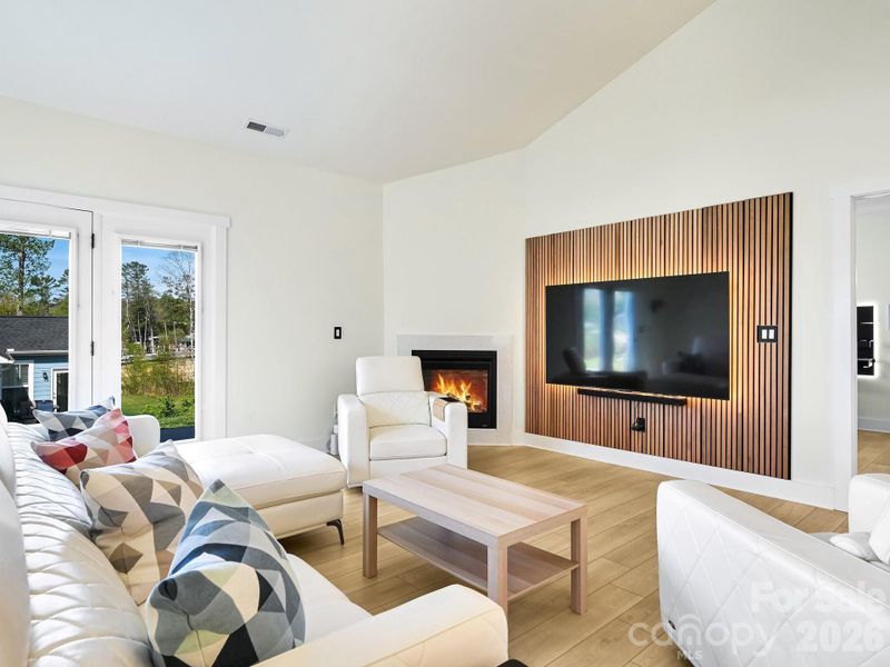 Custom wall panels and mounted TV and sound bar, may convey with home.