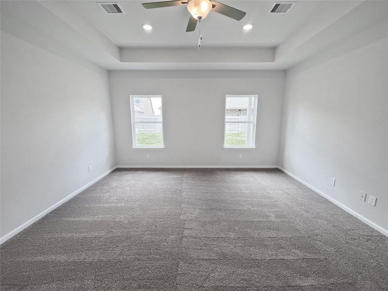 The Crawford- Primary Bedroom with Tray Ceiling. Home under construction. Sample floor plan photo used for illustrative purposes only. Upgrades, selections options, windows and colors may vary. The Crawford- Primary Bedroom with Tray Ceiling. Home under construction. Sample floor plan photo used for illustrative purposes only. Upgrades, selections options, windows and colors may vary.