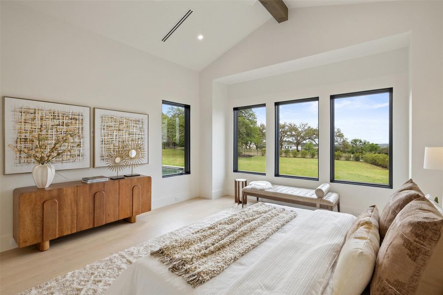 Bedroom with high vaulted ceiling, light wood-type flooring, beam ceiling, visible vents, and recessed lighting Bedroom with high vaulted ceiling, light wood-type flooring, beam ceiling, visible vents, and recessed lighting