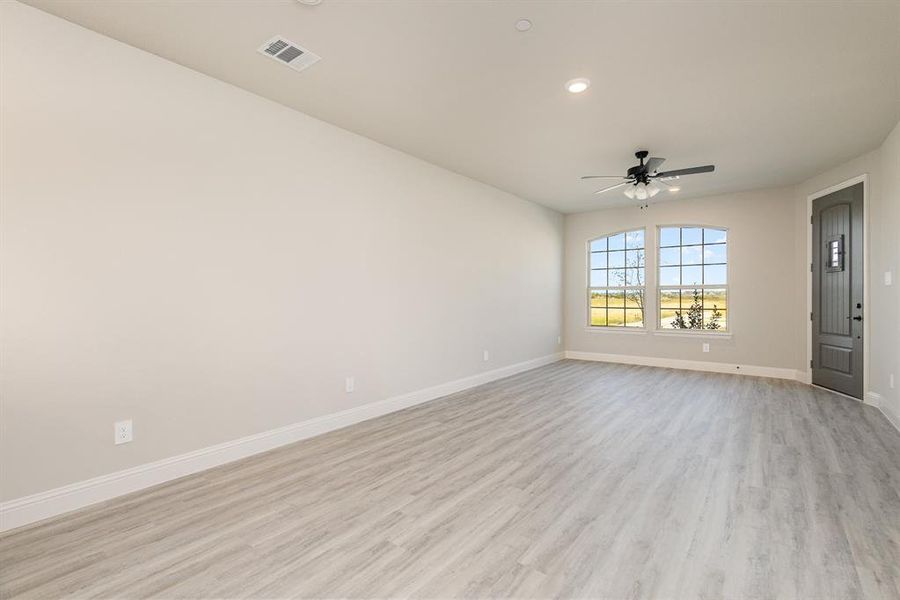 Spare room with light hardwood / wood-style flooring and ceiling fan