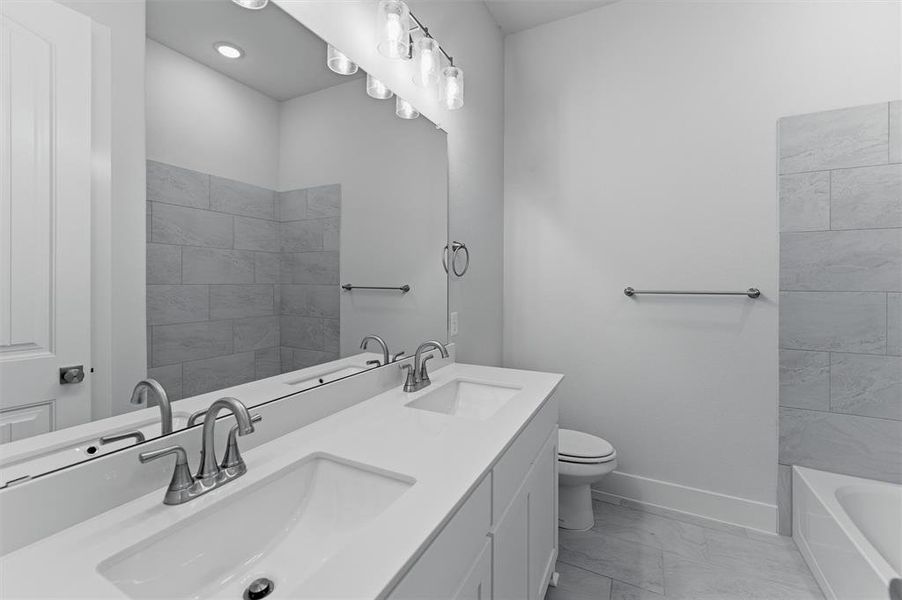 Dual vanity with undermount sinks and brushed nickel faucets, set against a full-width mirror