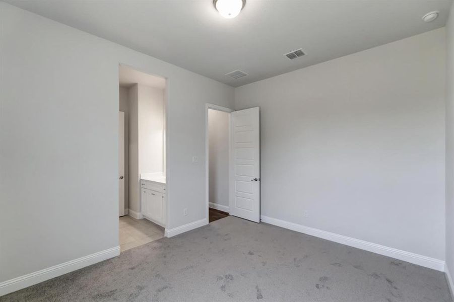 Unfurnished bedroom with light carpet