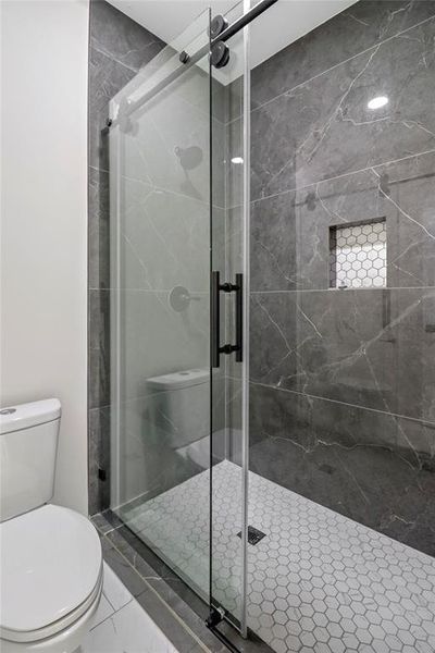 Primary toilet and stand-up shower separate from sink area.