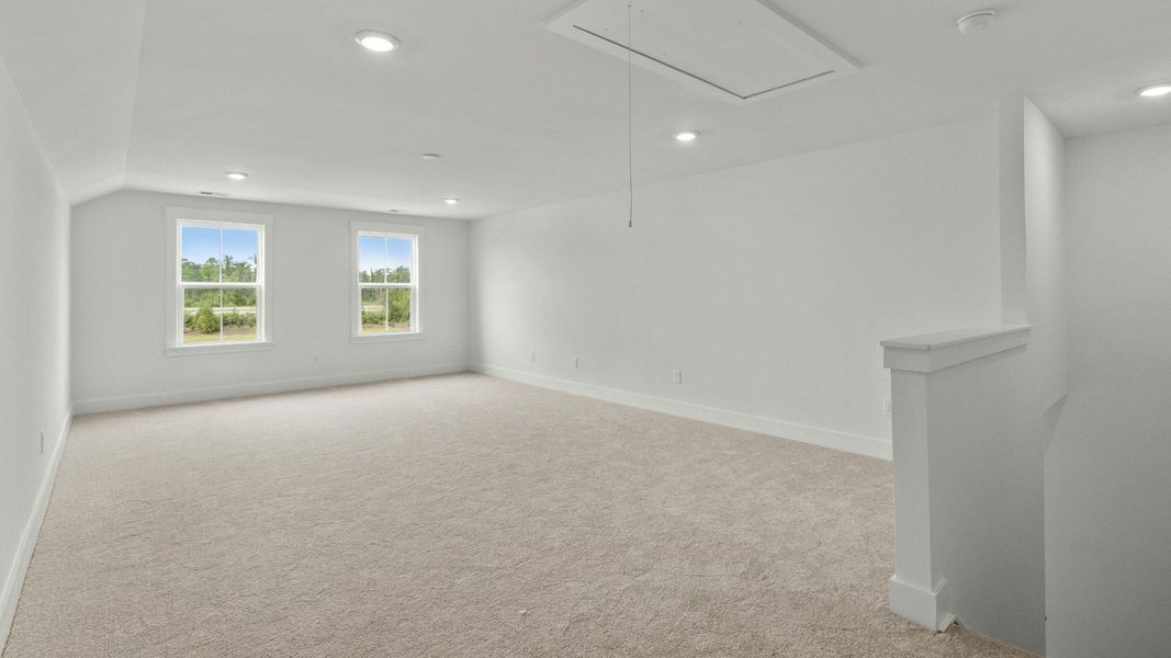 Spacious bonus room perfect for media, playroom, or game room at Chestnut Farms by DRB Homes