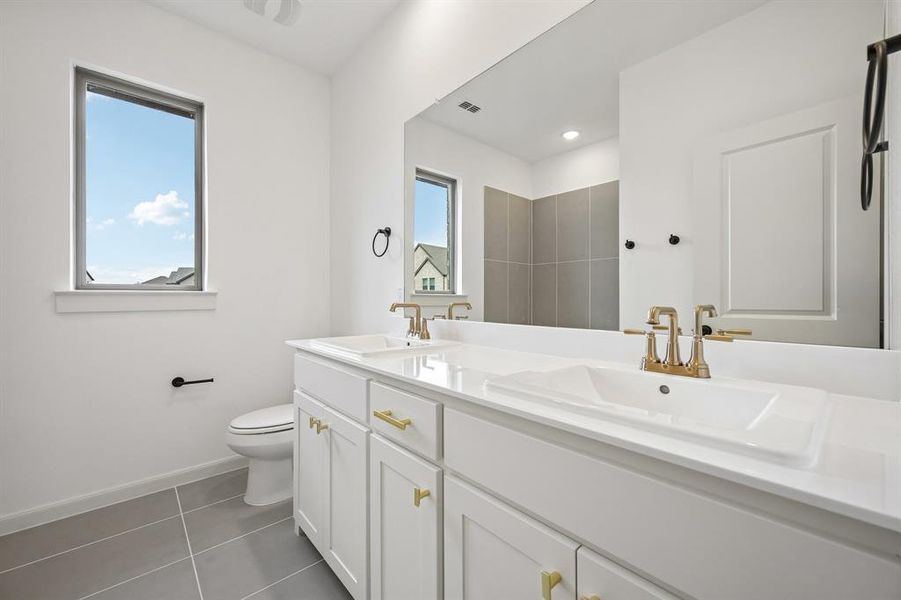 With dual sinks, guests will have their own vanity space in this lovely guest bath.