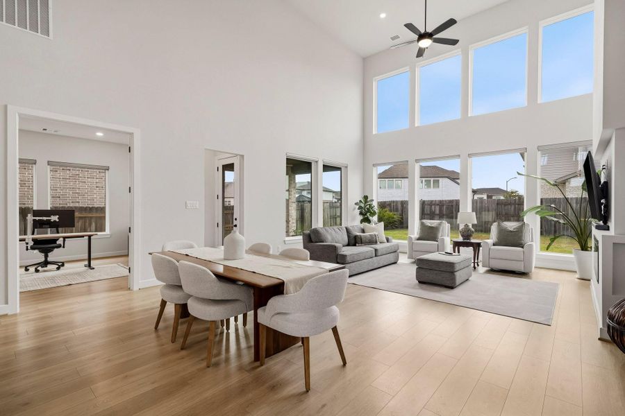 The dining area exudes understated luxury, with rich, warm luxury vinyl planked floors lending depth and sophistication to the space. A gracefully positioned entry just off the dining area leads to the private study, adding both architectural interest and a sense of refined flow.