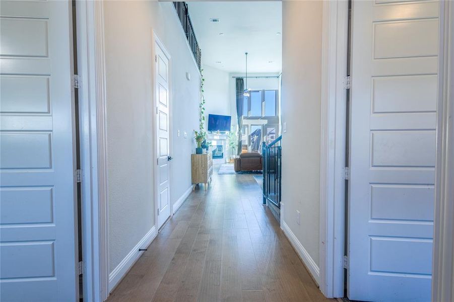 Hallway featuring wood finished floors and baseboards