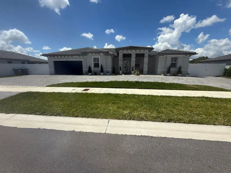 Front exterior of a new home in , Homestead, FL, highlighting curb appeal (Image 1). Front exterior of a new home in , Homestead, FL, highlighting curb appeal (Image 1).