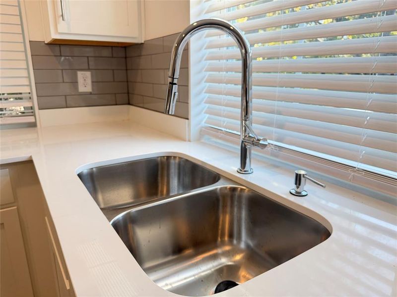 Kitchen view of backsplash and white cabinets