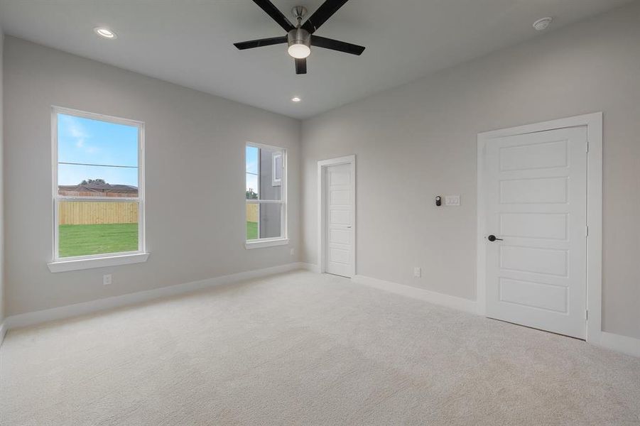 Unfurnished bedroom featuring carpet, baseboards, recessed lighting, and ceiling fan