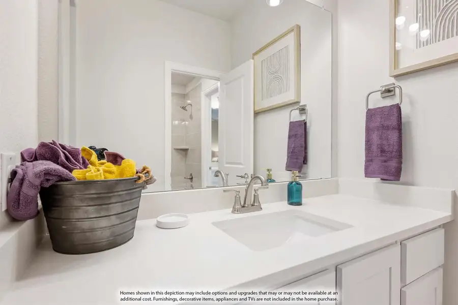 Bathroom vanity with white countertop, single sink, large mirror, and separate shower visible in background Bathroom vanity with white countertop, single sink, large mirror, and separate shower visible in background