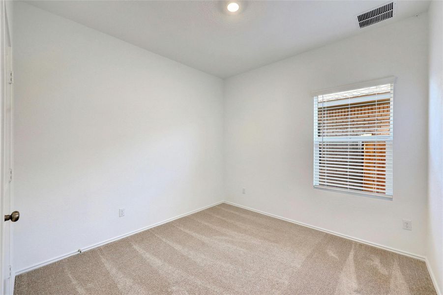 Spare room with light colored carpet and baseboards