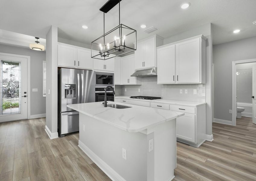 Full lite front door in the foyer and a kitchen with stainless steel applainces