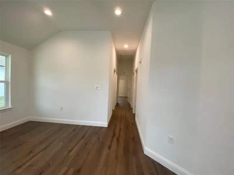 Recessed lighting, dark wood finished floors, and lofted ceiling Recessed lighting, dark wood finished floors, and lofted ceiling