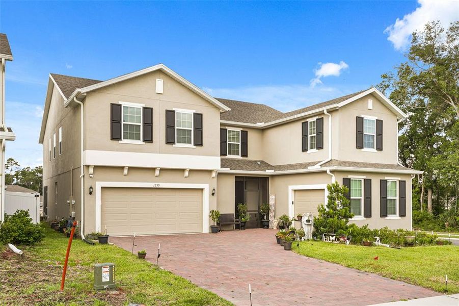 Front exterior of a new home in Beresford Woods, Deland, FL, highlighting curb appeal (Image 1). Front exterior of a new home in Beresford Woods, Deland, FL, highlighting curb appeal (Image 1).