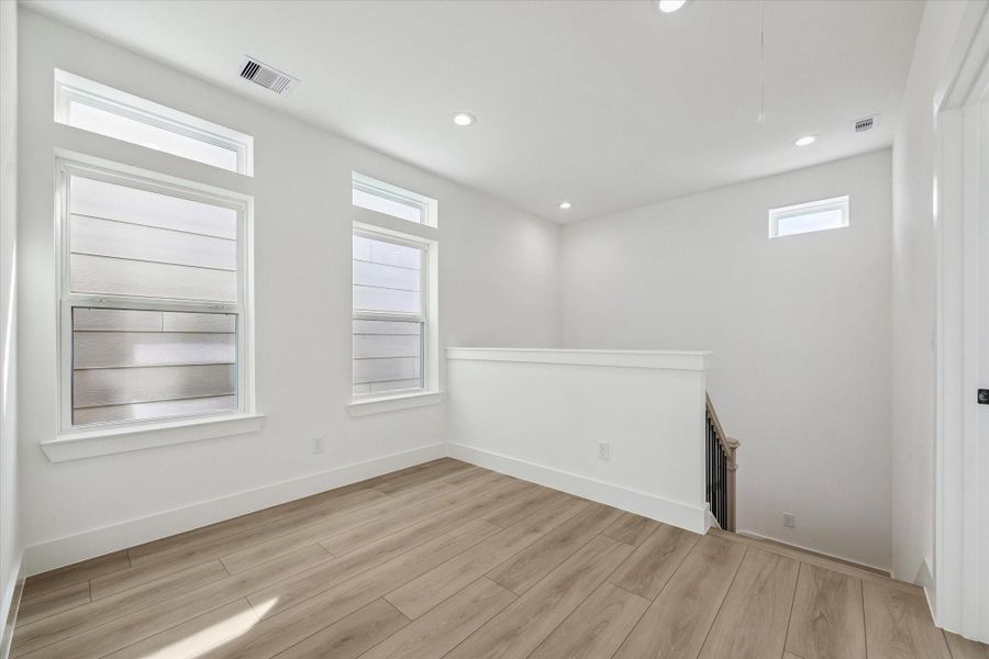 Comfortable bedroom with soft natural light and neutral flooring Comfortable bedroom with soft natural light and neutral flooring