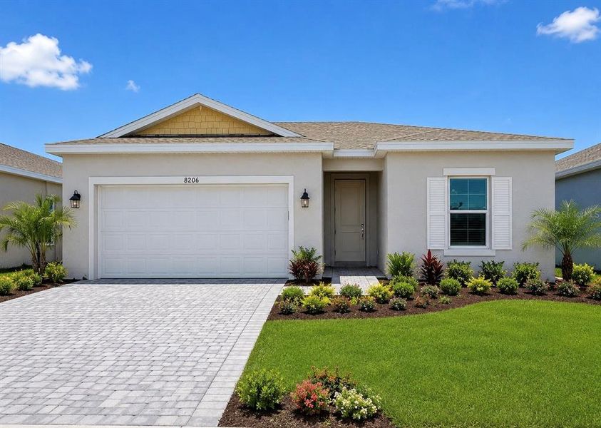 Front exterior of a new home in Island Lakes at Coco Bay, Englewood, FL, highlighting curb appeal (Image 6).